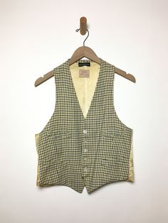 Just so good. Old wool vest with label intact. Gender neutral. As found, aged to perfection. Fabric: WoolLabel: Tattersall for Raleigh HaberdasherFit: M Measurements (flat): Armpit to armpit 19.5 inches Shoulder (across) 10.5 inches Arm opening 11.5 inches Length (back) 20.5 inches Waist 18.5 inches Condition: Good. Several small holes, some stains. Fitted Wool Vest Top, Tailored Cotton Vest For Fall, Fitted Plaid Sleeveless Vest, Classic Sleeveless Vest For Daywear, Fitted Sleeveless Plaid Vest, Tailored Vintage Wool Vest, Tailored Vintage Fall Vest, Vintage Sweater Vest For Fall Workwear, Classic Wool Vest For Spring