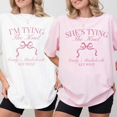 two women wearing matching shirts that say i'm tying the knot