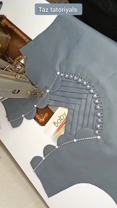 the sewing machine is cutting fabric with scissors and threading it to make an elephant - shaped skirt