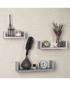 three white shelves with decorative items on them