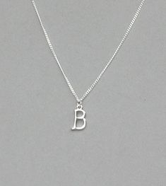 The initial is silver plated and measures 10 mm x 15 mm. It is strung on a silver plated tiny 1.3 mm curb chain with a lobster clasp closure. Choose the length from the drop down. To add a birthstone charm to this necklace, follow link below to purchase the charm.  https://www.etsy.com/listing/634099372/add-a-birthstone-charm?ga_search_query=add&ref=shop_items_search_1 Silver Adjustable Initial Pendant Charm Necklace, Classic Silver Charm Necklaces With Initials, Adjustable Silver Charm Necklace With Initials, Classic Silver Nickel-free Charm Necklaces, Classic Silver Nickel-free Charm Necklace, Lobster Clasp, Birthstone Charms, Cute Photos, Name Necklace