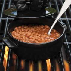 a pot filled with beans sitting on top of an oven