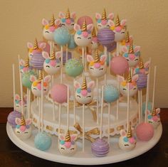 there is a cake that has many unicorn candies on top of it and some candy in the middle