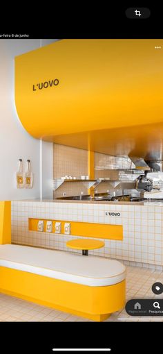 the yellow and white kitchen is clean and ready to be used as an appliance