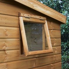 a small wooden building with a window on the side