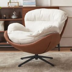 an egg chair sitting on top of a rug in front of a book shelf and bookshelf