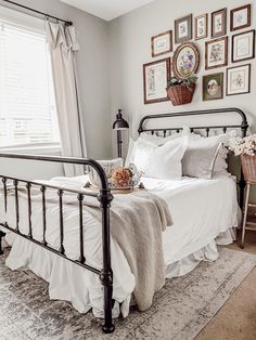 a bedroom with white bedding and pictures on the wall above it that says farmhouse cottage bedroom home decor inspo with ruffle pillows and shabby decor including vintage floral