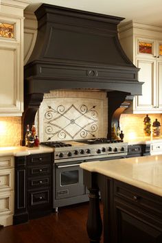 a stove top oven sitting inside of a kitchen next to an oven and countertop