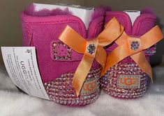 Infant Bling "Jesse Bow" UGG Boots in size (2/3), which is for 6-12 months for UGGs. These boots are brand new with tags and box. Embellished with "Light Pink AB" stones.  These stones seem like they were made for this boot. In different lights you catch the pink in the stones and the orange in other lights which sets the boot off perfectly❣️  Please message me with any question or concerns you may have. Thanks for stopping by and happy shopping. Bow Ugg Boots, Bow Ugg, Crib Shoes, Different Light, Shoes Booties, Ugg Boots, The Pink, Girls Shoes