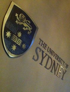 the university of sydney logo is displayed on a wall