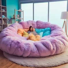 a woman laying in a large purple bean bag chair