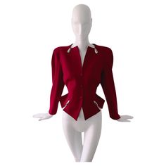 Stunning red Thierry Mugler blazer jacket with amazing silver bulllet details. Hiver Buick collection FW 1989. Adorned with chrome ornaments inspired by the 1959 Cadillac Eldorado. Very rare Thierry Mugler creation. Avant-garde & drama. Dark bordeaux red fitted Wool blazer with shiny silver metal bullet elements. Deep V-neck, Zigzag cutouts and typical Mugleresque fitted waist, feminine silhouette and strong shoulders. Closes with snap buttons on the front. Highlights are the silver metal bullet Mugler Blazer, Off Shoulder Jacket, Front Highlights, Girls Corset, Strong Shoulders, Silver Bullet, Cadillac Eldorado, Blazer And Skirt, Red Fits