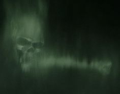 there is a skull in the dark with green light coming from its mouth and head