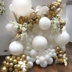 white and gold balloons are arranged on the floor