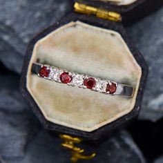 This touch-of-sparkle ring has alternating round garnets and round brilliant cut diamonds set across the top of the piece. It would be a great gift for a January birthday or someone who loves the deep dramatic red of garnets. The ring is crafted in 14k white gold and is currently a size 8.75. January Birthday, Sparkling Rings, Garnet Rings, The Deep, Round Brilliant Cut Diamond, Brilliant Cut Diamond, Round Brilliant, Band Ring, Band Rings