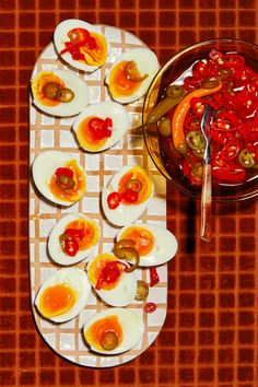 an assortment of deviled eggs with pickles and ketchup