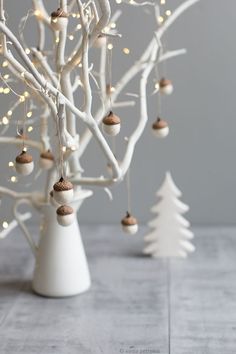 a white tree with ornaments hanging from it's branches