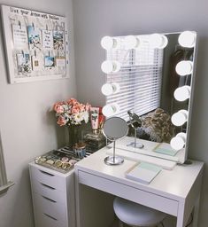 a white desk topped with a mirror and a vanity