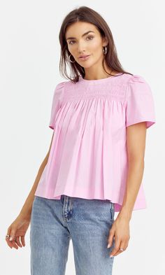 Cotton yoke blouse designed with short sleeves and pleated texture. Easy to style with any bottoms. Top Bubblegum pink Self: 100% Cotton Length: 23" Chest: 17 3/4" Hand wash in cold water. Lay flat to dry. Low iron. Model is wearing a size small Style #: G242T6942 Casual Pintuck Short Sleeve Tops, Casual Short Sleeve Tops With Pintucks, Short Sleeve Tops With Pintucks For Daywear, Feminine Pintuck Top For Summer, Feminine Pintucks Top For Summer, Feminine Summer Top With Pintucks, Feminine Summer Tops With Pintucks, Casual Smocked Short Sleeve Top For Daywear, Pink Cotton Smocked Top