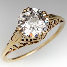 an antique style diamond ring with filigree accents