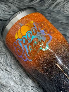 an orange and blue glittered tumbler with the word boo's on it