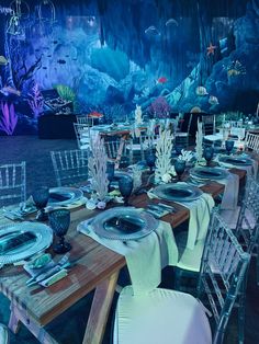 a table set up with plates and silverware for an underseam wedding reception