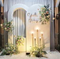 a wedding stage set up with candles and flowers