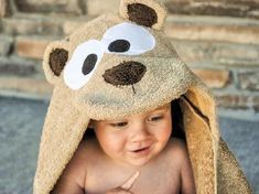 a small child wearing a teddy bear hat