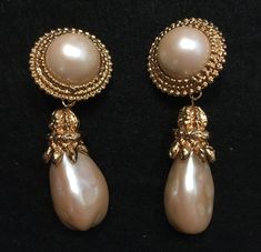 "Big Bold  Marla Buck Vintage Gold and Pearl Drop Clip Earrings-These Marla Buck show-stoppers were purchased  at Saks Fifth Avenue, NY. Round synthetic mabe`style pearls are surrounded by filligree gold rings from which dangles a long pearl with a gold tone cap. 3\" long 1 1/2 \" at widest If you are a Marla Buck collector, these are for you! Real stunners." October Jewelry, Pearl Jewels, Gold Clips, Jewelry Essentials, Big Earrings, Vintage Pearls, Fantasy Jewelry, Girly Jewelry, Clip Earrings