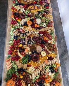 a long tray filled with lots of different types of food on top of a table