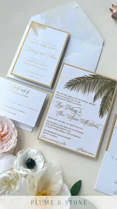 the wedding stationery is laid out with flowers