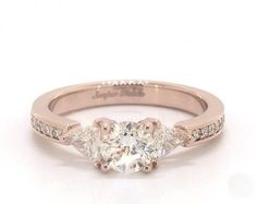 three stone diamond engagement ring in 18k rose gold with channel set diamonds on the band