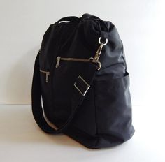 *** Please check 'shop announcement' for production time and delivery before your purchase. ***This sturdy bag is made from black water resistant nylon with black nylon lining. It's very roomy and suitable to be used as your all purpose bag, diaper bag, school bag, messenger bag, everyday tote, travel bag and messenger bag. You can just use the wet cloth to wipe the dirt out once it's get dirty.If you would rather have the bag in different colors (exterior and interior), please select your choic Black Tote Diaper Bag With Zipper Closure, Functional Black Diaper Bag With Zipper Closure, Black Travel Bag With Zipper Pocket For School, Black Nylon Everyday Diaper Bag, Everyday Black Nylon Diaper Bag, Black Nylon Diaper Bag For Everyday Use, Black School Travel Bag With Zipper Pocket, Black Nylon Diaper Bag For Daily Use, Black Diaper Shoulder Bag With Zipper Closure