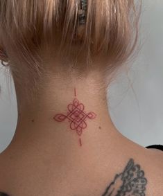 a woman with a tattoo on her neck and behind her head is a red cross