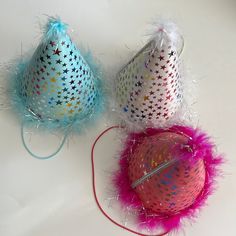 three colorful party hats sitting next to each other on top of a white countertop