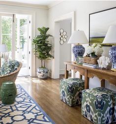 a living room filled with lots of furniture next to a large mirror on the wall