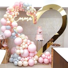 the balloon arch is decorated with pink, blue and white balloons for an elegant birthday party