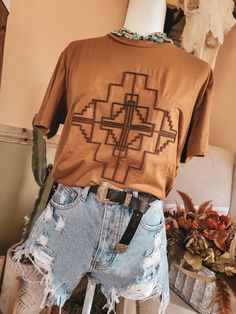 Zoom on in. It’s our new way to graphic tee. It’s an embroidered brush type technique that gives you some cool texture to rev up any ol t-shirt. And we are super Excited to bring you SOMETHING DIFFERENT. it's got a really RAD southwestern aztec graphic. it's giving serious desert vibes. saddle body. contrasting rust brush embroidery. regular-sized fit. running true to size. Brush Embroidery, Mom Graphic Tees, Western Graphic Tees, Western Style Outfits, Desert Vibes, Stitch Shirt, Brush Type, Cute Preppy Outfits, Girl Fits