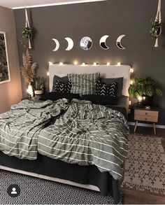 a bed room with a neatly made bed and lots of lights on the wall above it