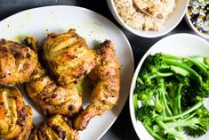 there are many different types of food on the plate and in bowls next to each other