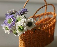 a basket with flowers in it sitting on a table