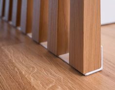 a close up view of a wooden floor with the bottom part of an object sticking out