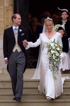 the bride and groom are walking down the steps