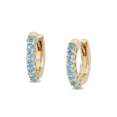 Casual and fun, these Swiss blue topaz huggie hoop earrings add a pop of color to your attire. 10K gold Each huggie hoop is adorned with dainty Swiss blue topaz along the front edge Hinged backs Yellow Gold Birthstone Huggie Earrings, 14k Gold Huggie Earrings With Gemstone, Fine Jewelry Huggie Earrings With Birthstone, 14k Gold Gemstone Huggie Earrings, Blue Huggie Hoop Earrings, Blue Huggie Hoop Earrings In Fine Jewelry, Small Hoop Huggie Earrings With Birthstone For Anniversary, Anniversary Birthstone Huggie Earrings In Small Hoop, Anniversary Small Hoop Huggie Earrings With Birthstone