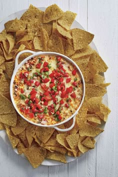 a white plate topped with tortilla chips and salsa