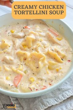 creamy chicken tortellini soup in a white bowl on top of a gray napkin