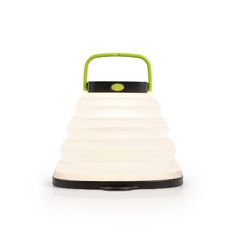 a white and green light with a black handle on the top, sitting on a white surface