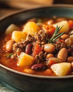 a close up of a bowl of food with meat and beans