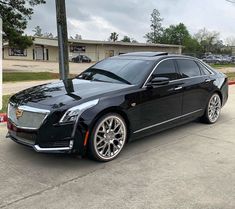 a black car parked in front of a building