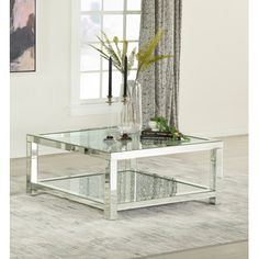 a glass coffee table in front of a window